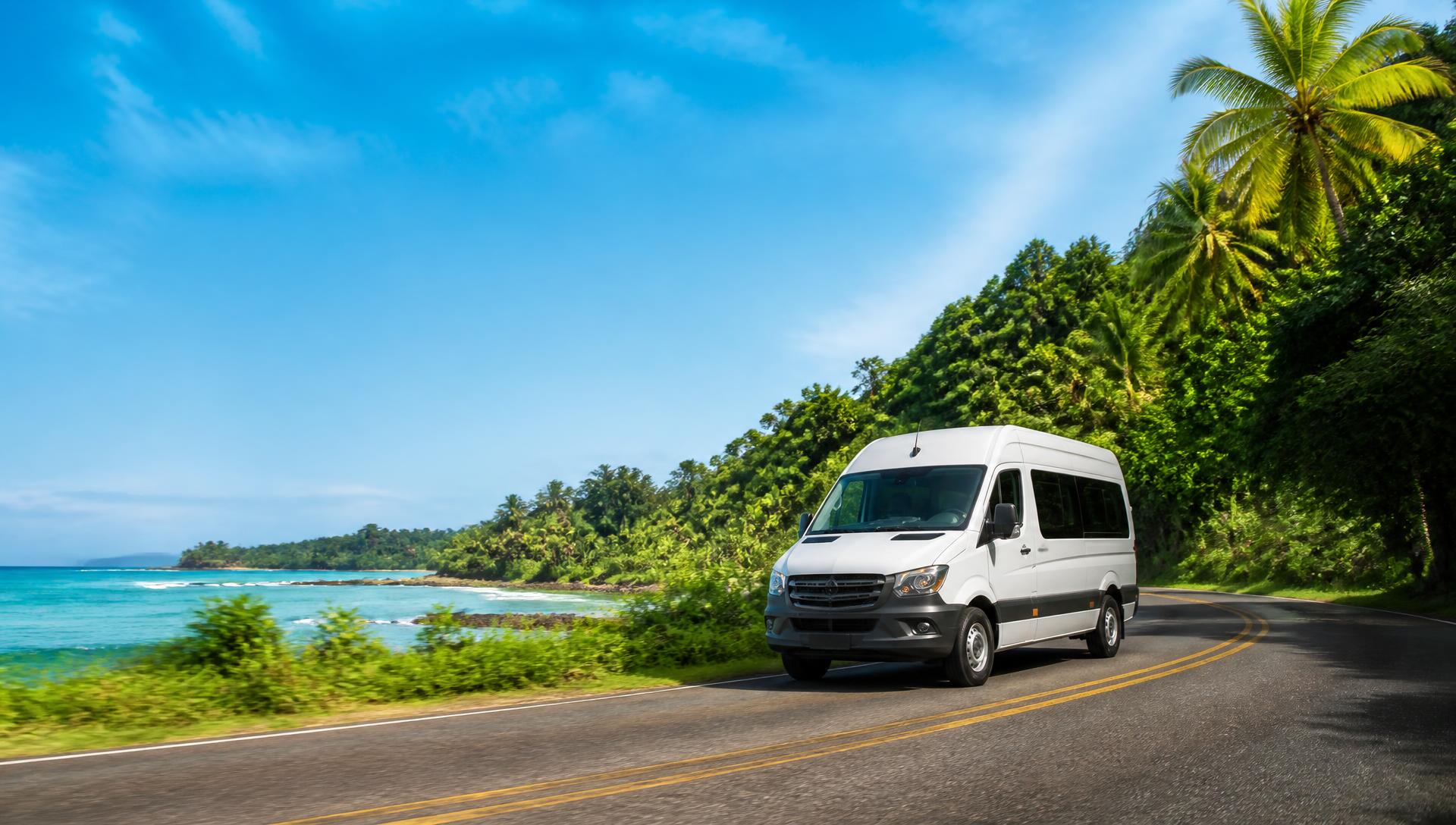 A passenger shuttle traveling on a Costa Rican coastal road